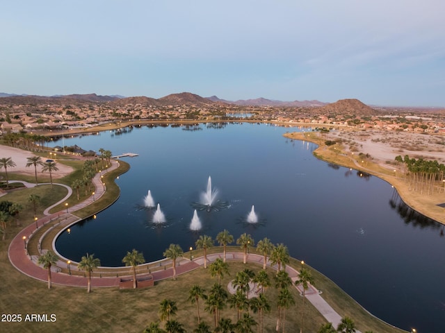 drone / aerial view with a water and mountain view