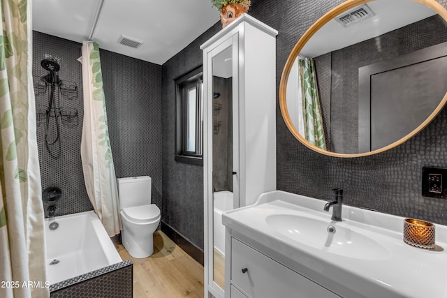 full bathroom featuring toilet, vanity, shower / bath combination with curtain, and wood-type flooring