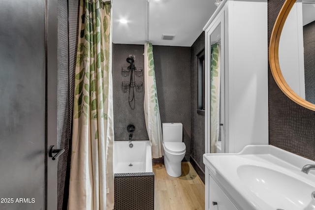 full bathroom with toilet, vanity, wood-type flooring, and shower / bath combo with shower curtain