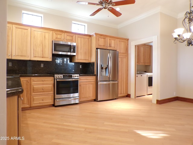 kitchen featuring washing machine and clothes dryer, light wood-type flooring, ornamental molding, stainless steel appliances, and backsplash