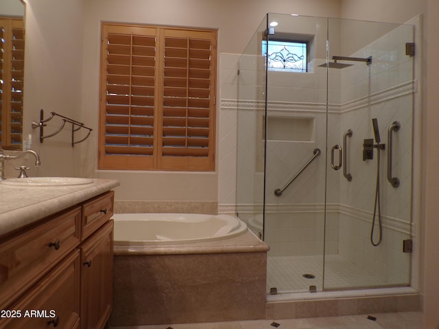 bathroom with vanity and independent shower and bath