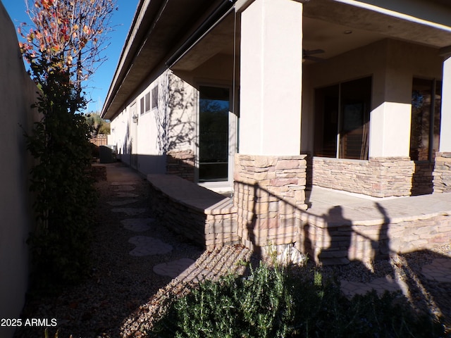 view of property exterior featuring ceiling fan