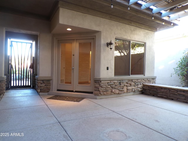 property entrance with a patio and french doors