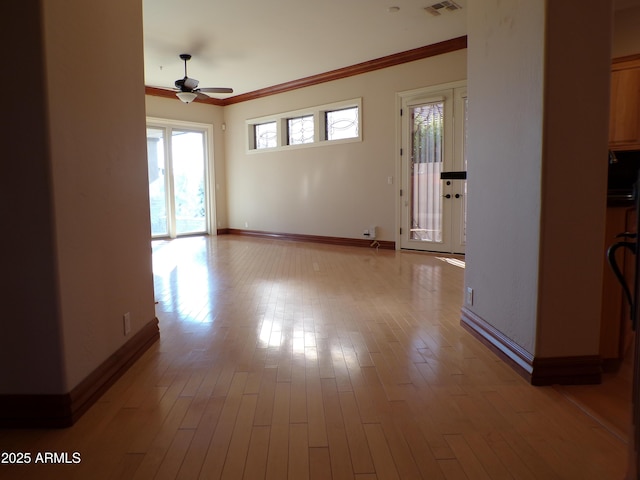 empty room with crown molding, light hardwood / wood-style flooring, and ceiling fan