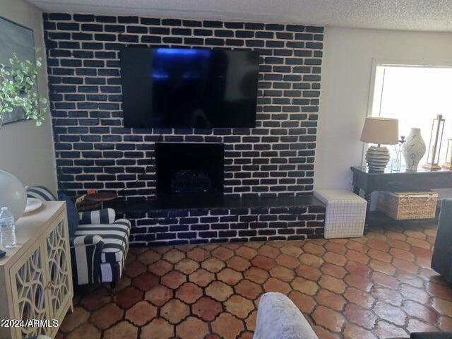 5539 N 31st Ln, Phoenix, AZ 85017 - living room featuring a textured ceiling and a fireplace