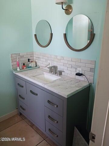 5539 N 31st Ln, Phoenix, AZ 85017 - bathroom with tasteful backsplash, vanity, and tile patterned flooring