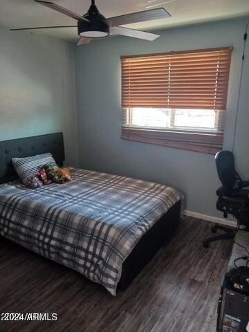 5539 N 31st Ln, Phoenix, AZ 85017 - bedroom with wood finished floors, ceiling fan, and baseboards