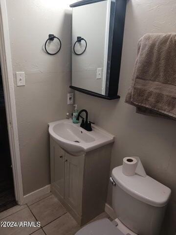 5539 N 31st Ln, Phoenix, AZ 85017 - half bath with toilet, vanity, tile patterned floors, and baseboards