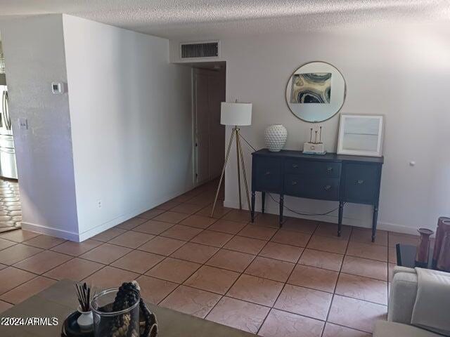 5539 N 31st Ln, Phoenix, AZ 85017 - tiled living area with a textured ceiling and baseboards