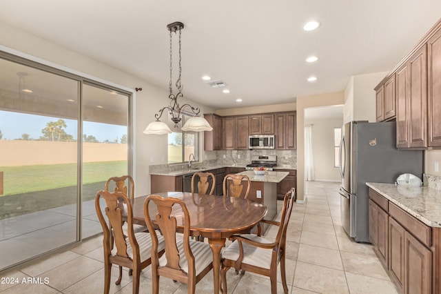 tiled dining space featuring sink