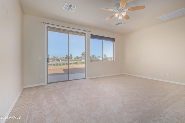 spare room featuring ceiling fan and light colored carpet