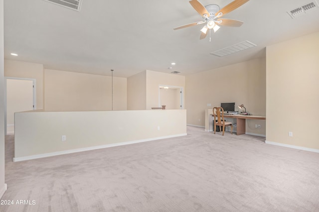 interior space featuring light carpet and ceiling fan