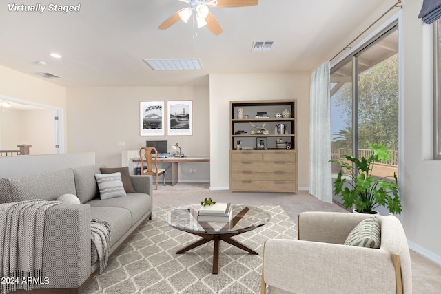 living room with light colored carpet and ceiling fan