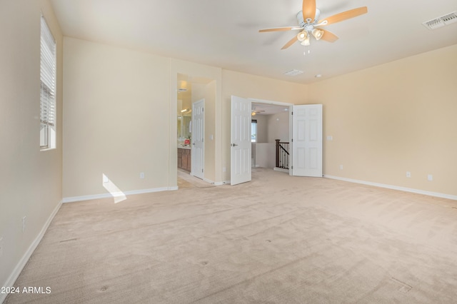 unfurnished room featuring ceiling fan and light colored carpet