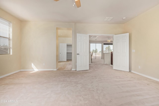 carpeted spare room featuring ceiling fan