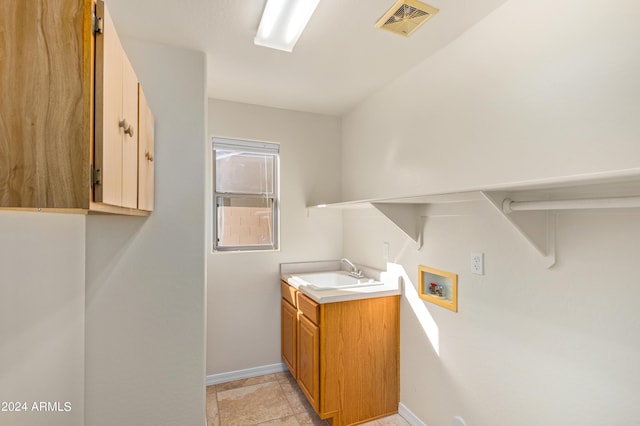 washroom featuring cabinets, sink, and washer hookup