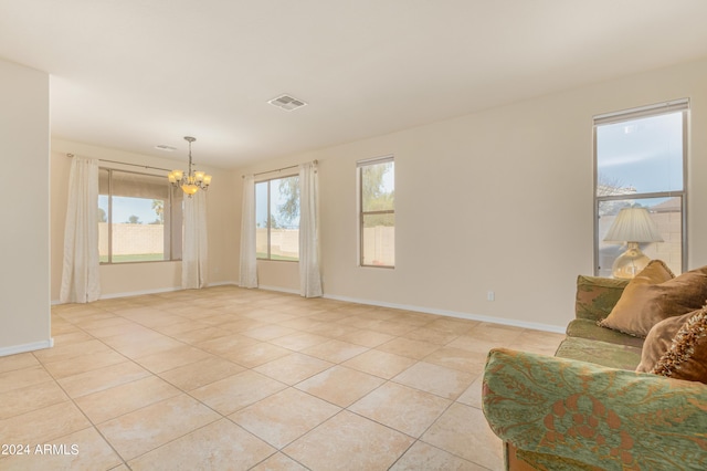 living room with light tile patterned flooring and a notable chandelier