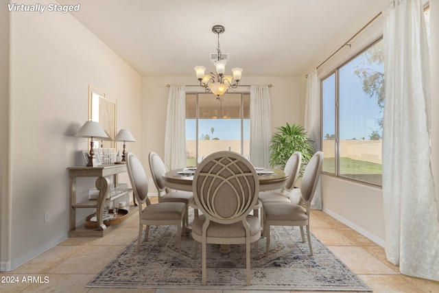 dining room with an inviting chandelier, light tile patterned flooring, and a wealth of natural light