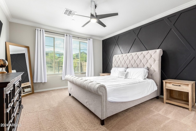 carpeted bedroom featuring crown molding and ceiling fan