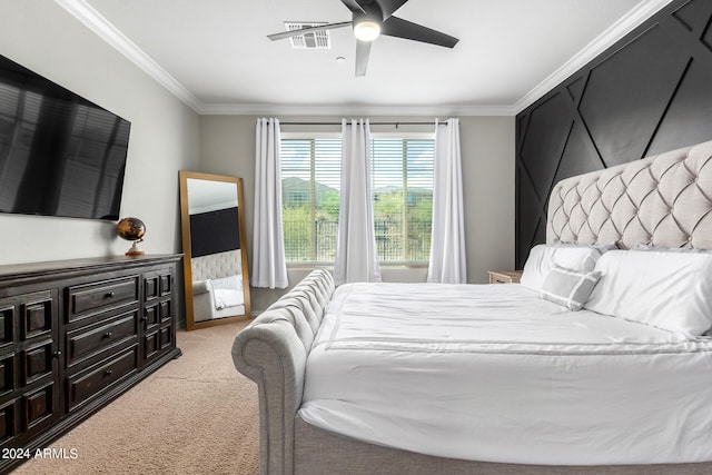 carpeted bedroom with ceiling fan and crown molding