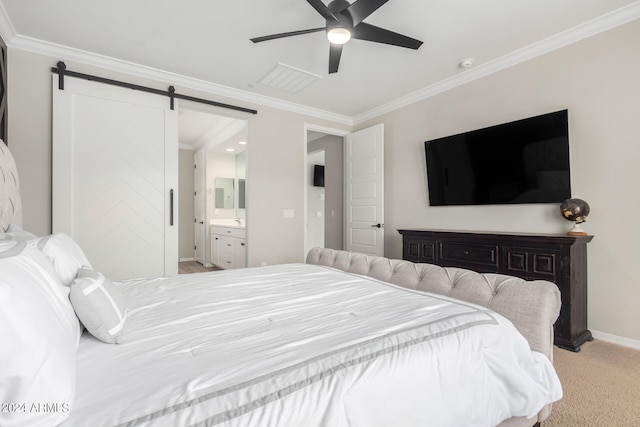 bedroom with light carpet, crown molding, ensuite bath, ceiling fan, and a barn door