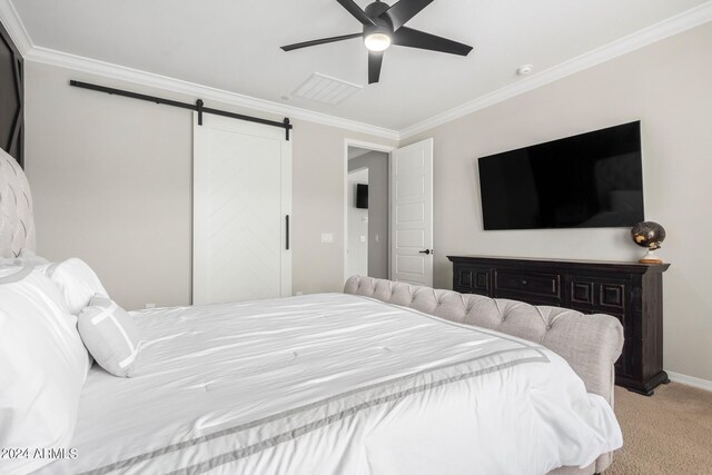 carpeted bedroom featuring a barn door, ceiling fan, and crown molding