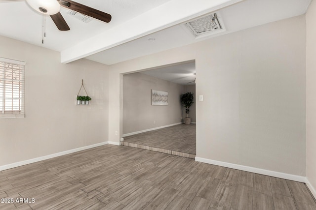 5649 W Holly St, Phoenix, AZ 85035 - unfurnished room featuring ceiling fan, wood finished floors, and beamed ceiling