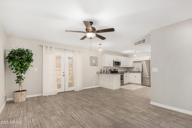 5649 W Holly St, Phoenix, AZ 85035 - unfurnished living room featuring french doors, light wood-style floors, and ceiling fan