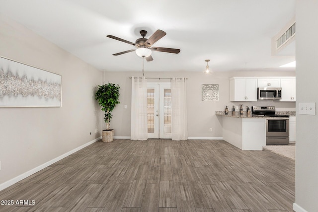 5649 W Holly St, Phoenix, AZ 85035 - kitchen with appliances with stainless steel finishes, french doors, wood finished floors, ceiling fan, and white cabinets
