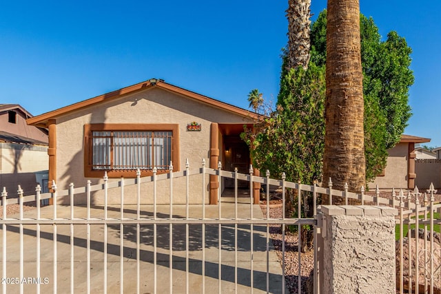 5649 W Holly St, Phoenix, AZ 85035 - view of front of home with a fenced front yard, stucco siding, and a gate