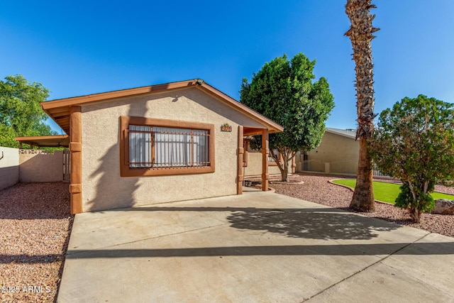 5649 W Holly St, Phoenix, AZ 85035 - view of front of home with stucco siding and a patio area