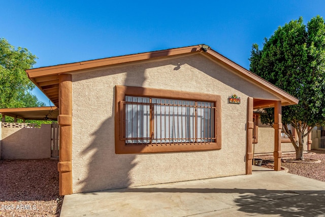 5649 W Holly St, Phoenix, AZ 85035 - view of side of property with stucco siding and a patio area