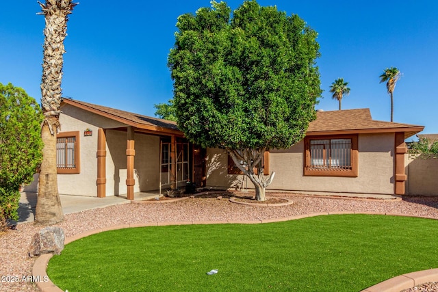 5649 W Holly St, Phoenix, AZ 85035 - rear view of property featuring stucco siding and a lawn