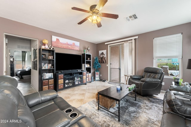 tiled living room with ceiling fan