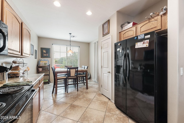 kitchen with light tile patterned flooring, pendant lighting, and black appliances