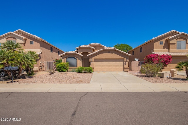 8648 W Fargo Dr, Peoria, AZ 85382 - mediterranean / spanish-style house with stucco siding, fence, a tile roof, concrete driveway, and an attached garage
