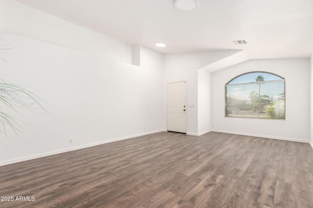 8648 W Fargo Dr, Peoria, AZ 85382 - empty room featuring dark wood finished floors, visible vents, lofted ceiling, and baseboards