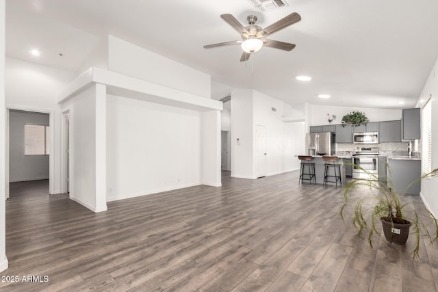 8648 W Fargo Dr, Peoria, AZ 85382 - living room featuring a ceiling fan, vaulted ceiling, and dark wood finished floors