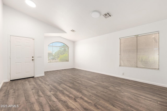 8648 W Fargo Dr, Peoria, AZ 85382 - empty room with dark wood-style floors, visible vents, lofted ceiling, and baseboards