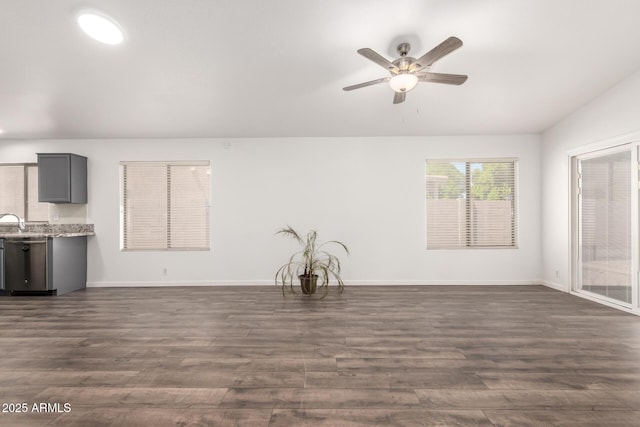8648 W Fargo Dr, Peoria, AZ 85382 - unfurnished living room featuring a ceiling fan, a sink, baseboards, and dark wood-type flooring