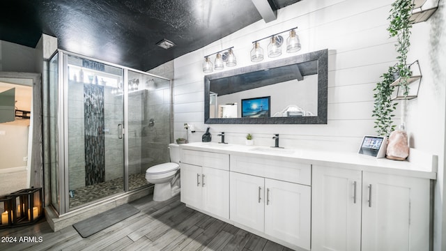 bathroom with walk in shower, vanity, hardwood / wood-style flooring, vaulted ceiling with beams, and toilet