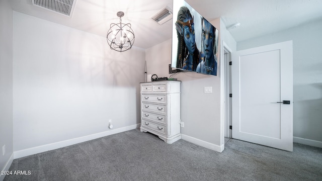 unfurnished bedroom with carpet and an inviting chandelier