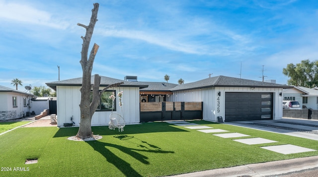 view of front of home with a front yard and a garage