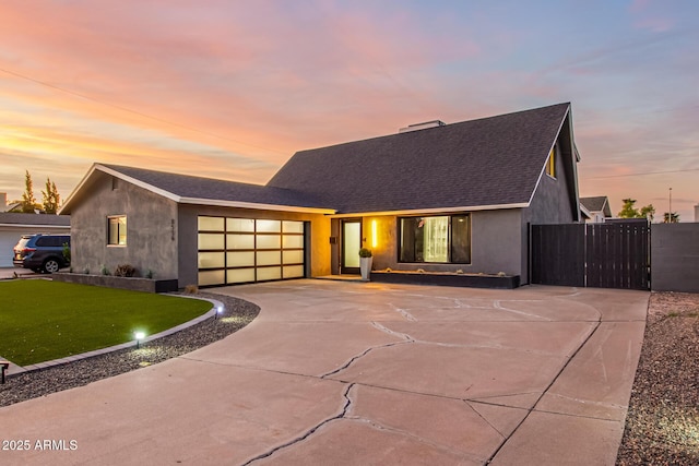 view of front of property featuring a yard and a garage