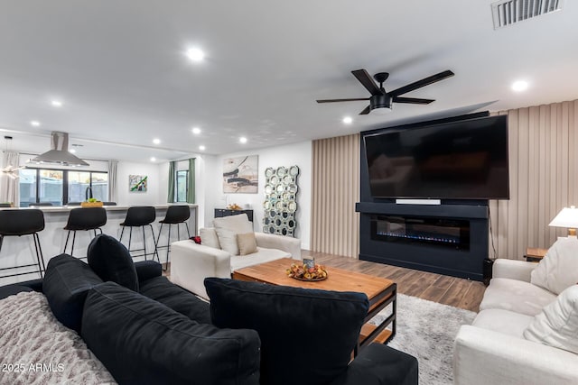 living room featuring ceiling fan and light wood-type flooring