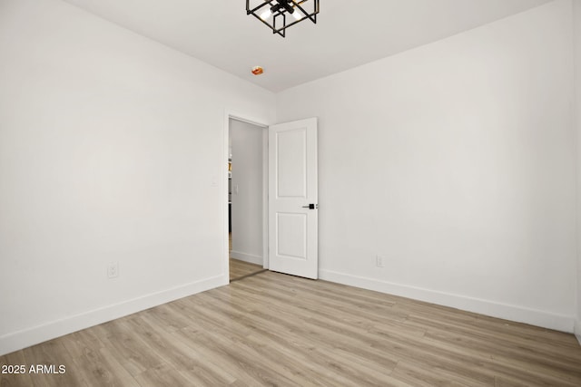 empty room featuring baseboards and wood finished floors