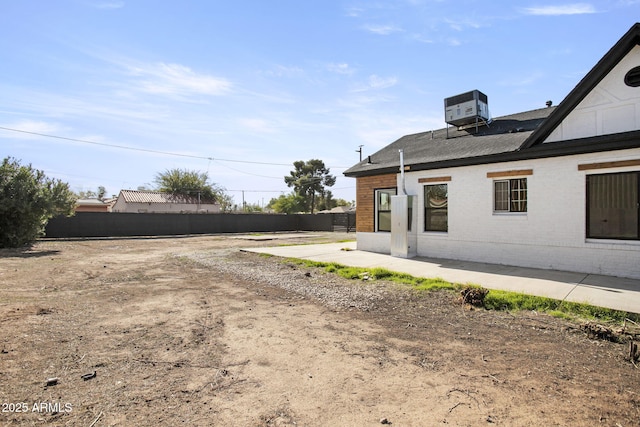 view of yard with central AC, a patio, and fence