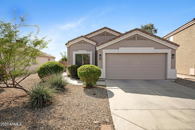 view of front of property with an attached garage, stucco siding, and concrete driveway