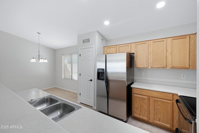 kitchen featuring range with electric cooktop, stainless steel refrigerator with ice dispenser, visible vents, a sink, and a chandelier