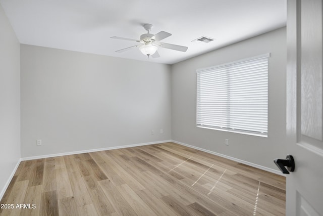 unfurnished room featuring light wood-type flooring, baseboards, ceiling fan, and visible vents